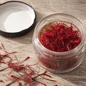 Top view of pure Mongra saffron threads in a glass jar