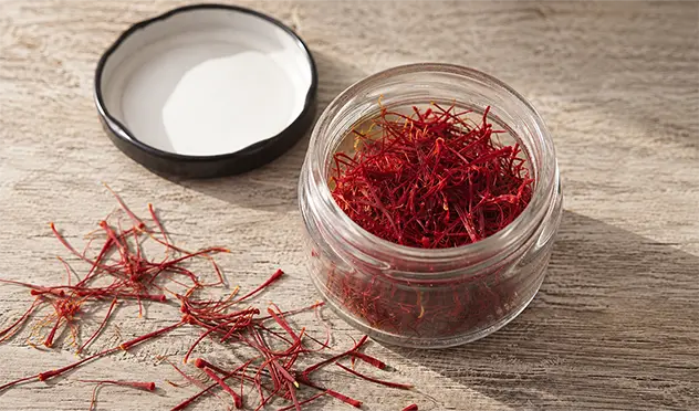 Top view of pure Mongra saffron threads in a glass jar